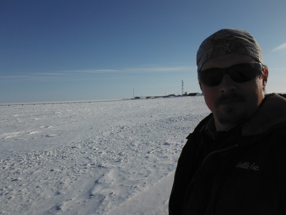 Less than a mile behind me is our fuel depot, on the edge of a frozen seascape.