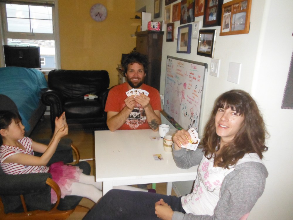 Samantha and Jason playing cards with our new friends at the kids table.