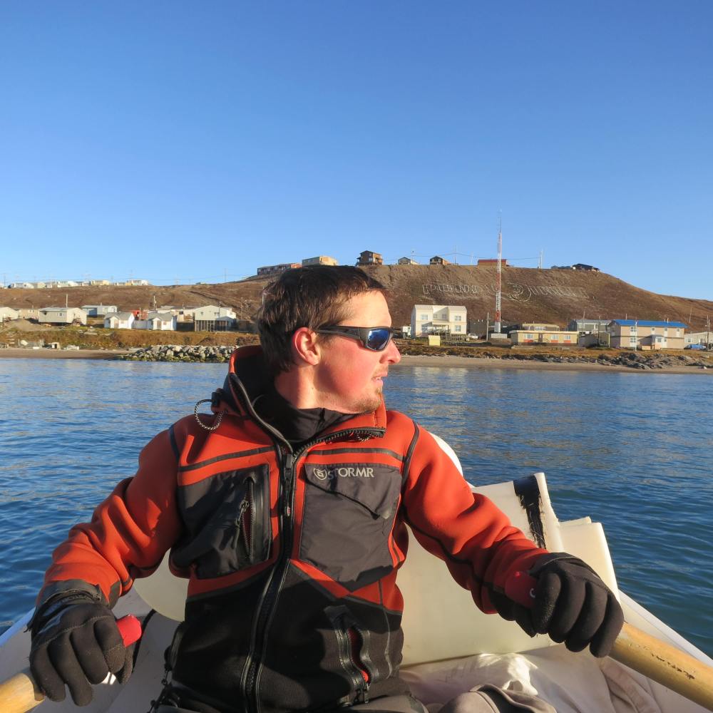 Rowing the tender into Pond Inlet, having transited the Northwest Passage